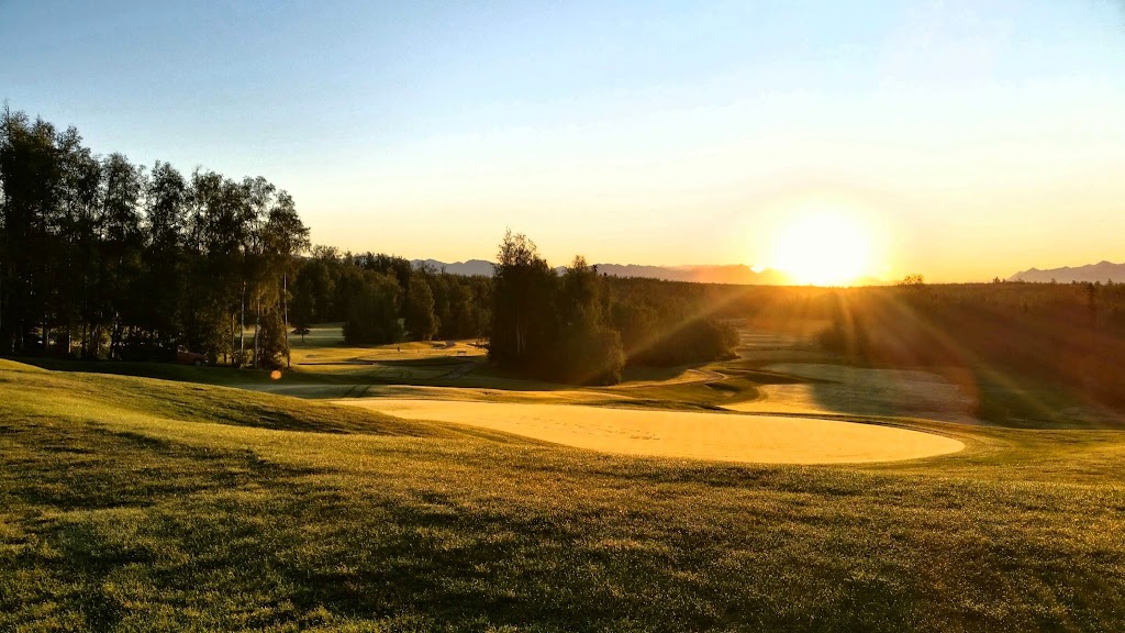 Panoramic view of a lush green golf course at Settlers Bay Golf Course. Smooth