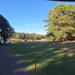 Panoramic view of a lush green golf course at Seven Lakes Country Club. Smooth