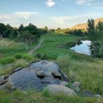 Panoramic view of a lush green golf course at Shadow Valley Golf Course. Smooth