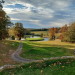 Panoramic view of a lush green golf course at Shady Hollow Golf Course. Smooth