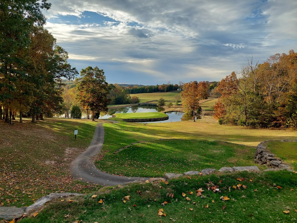 Panoramic view of a lush green golf course at Shady Hollow Golf Course. Smooth