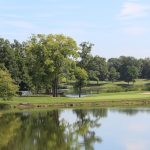 Panoramic view of a lush green golf course at Shaker Run Golf Club. Smooth