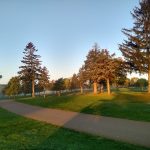 Panoramic view of a lush green golf course at Shamrock Golf Course. Smooth