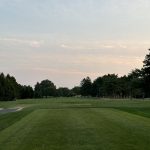 Panoramic view of a lush green golf course at Shark River Golf Course. Smooth