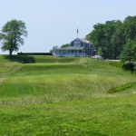 Panoramic view of a lush green golf course at Shelter Island Country Club. Smooth
