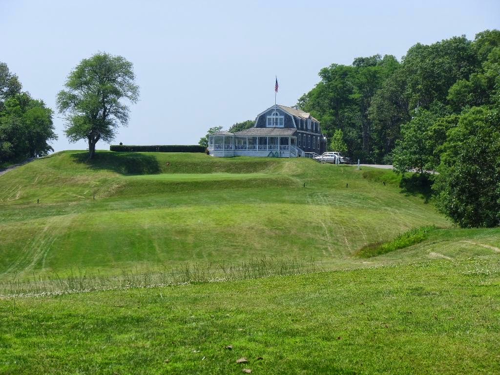 Panoramic view of a lush green golf course at Shelter Island Country Club. Smooth