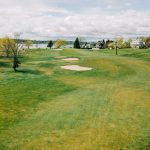 Panoramic view of a lush green golf course at Shennecossett Golf Course. Smooth