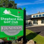 Panoramic view of a lush green golf course at Shepherd Hills Golf Club. Smooth