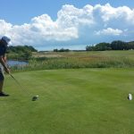 green grass with the flag in the hole.