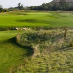 Panoramic view of a lush green golf course at Shepherd's Crook Golf Course. Smooth