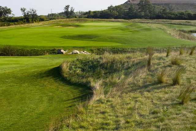 Panoramic view of a lush green golf course at Shepherd's Crook Golf Course. Smooth