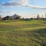 Panoramic view of a lush green golf course at Shingle Creek Golf Club. Smooth