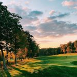 Panoramic view of a lush green golf course at Shining Rock Golf Club. Smooth