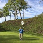 green grass with the flag in the hole.