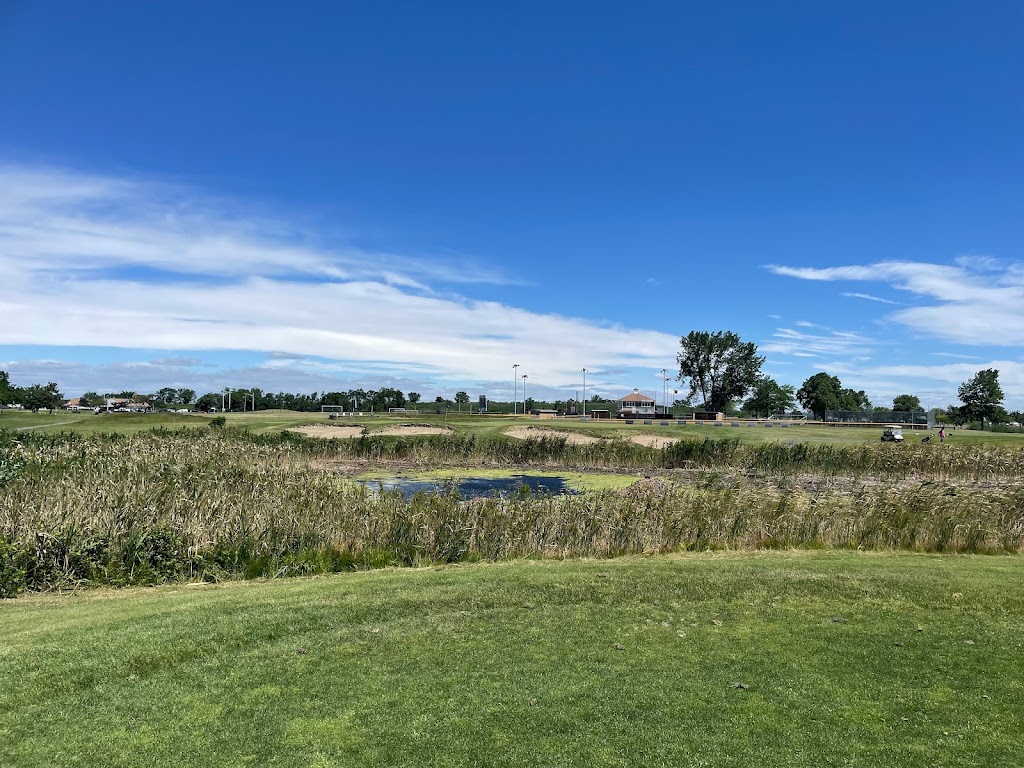 Panoramic view of a lush green golf course at Short Beach Golf Course. Smooth