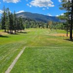 Panoramic view of a lush green golf course at Shoshone Golf Club. Smooth