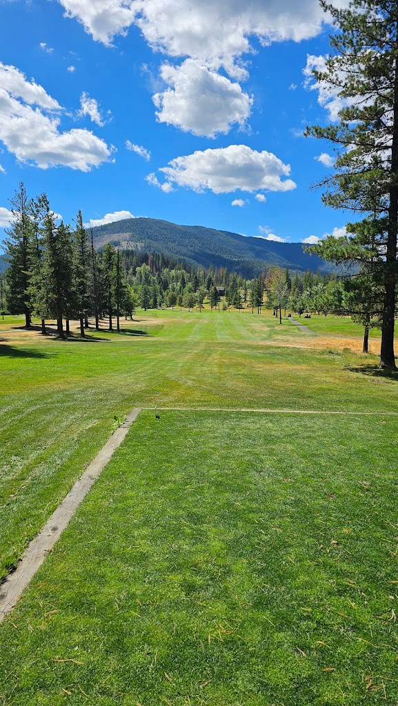 Panoramic view of a lush green golf course at Shoshone Golf Club. Smooth