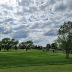 Panoramic view of a lush green golf course at Sierra Hills Golf Club. Smooth