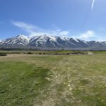 Panoramic view of a lush green golf course at Sierra Sage Golf Course. Smooth