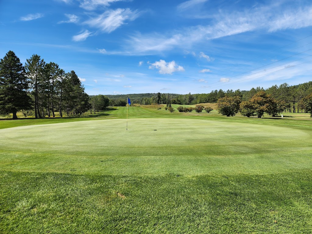 Panoramic view of a lush green golf course at Silver Bay Golf Course. Smooth
