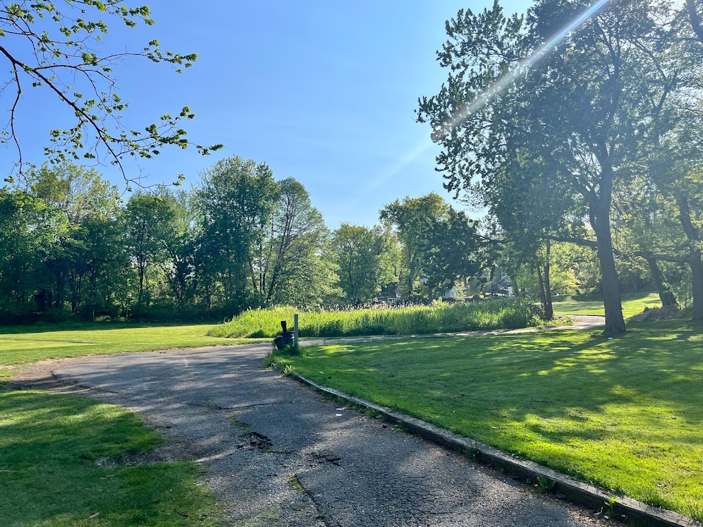 Panoramic view of a lush green golf course at Silver Lake Golf Course. Smooth