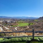 Panoramic view of a lush green golf course at Silver Oak Golf Course. Smooth