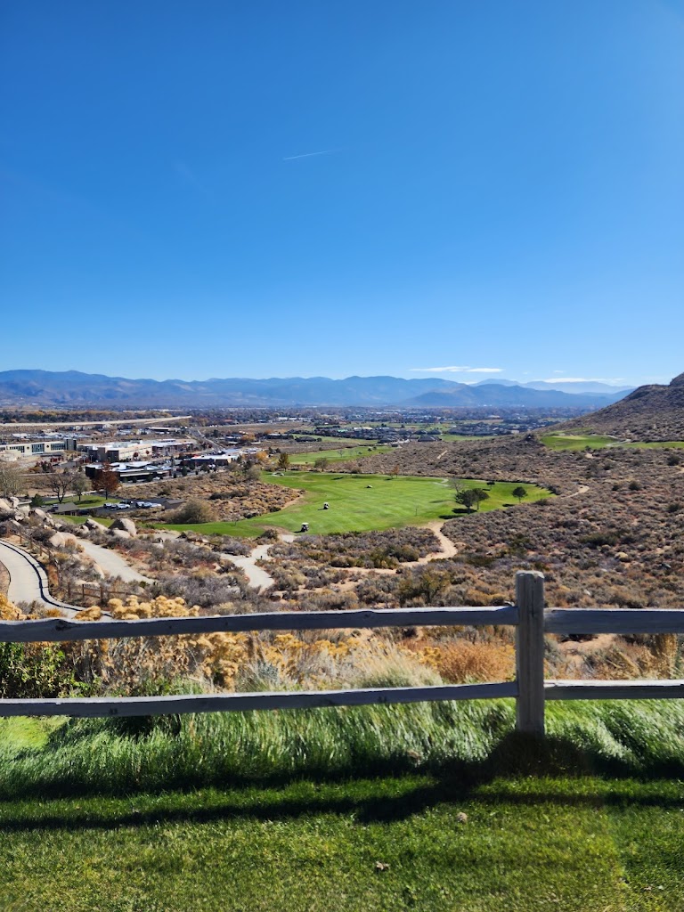 Panoramic view of a lush green golf course at Silver Oak Golf Course. Smooth