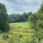 Panoramic view of a lush green golf course at Silver Ridge Golf Course. Smooth