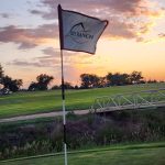 Panoramic view of a lush green golf course at Sky Ranch Golf Course. Smooth