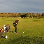green grass with the flag in the hole.