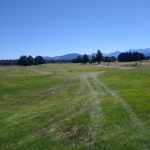 Panoramic view of a lush green golf course at Sky Ridge Golf Course Center. Smooth