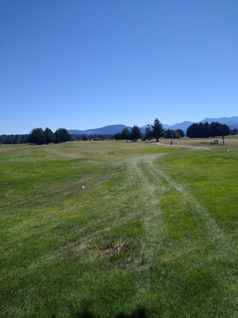 Panoramic view of a lush green golf course at Sky Ridge Golf Course Center. Smooth