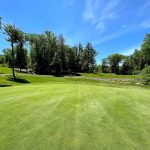 Panoramic view of a lush green golf course at Skytop Mountain Golf Club. Smooth