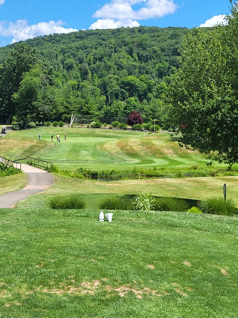 Panoramic view of a lush green golf course at Sleeping Giant Golf Course. Smooth