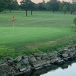 Panoramic view of a lush green golf course at Smiley's Golf Complex. Smooth