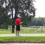 green grass with the flag in the hole.