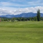 Panoramic view of a lush green golf course at Snoqualmie Falls Golf Course. Smooth