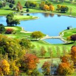 Panoramic view of a lush green golf course at Snow Hill Golf Course. Smooth