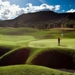 Panoramic view of a lush green golf course at Snowmass Club Golf Course. Smooth