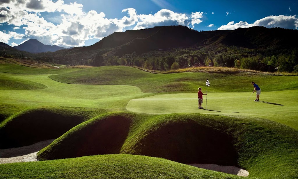 Panoramic view of a lush green golf course at Snowmass Club Golf Course. Smooth