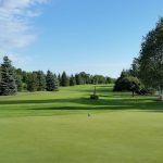 Panoramic view of a lush green golf course at Songbird Hills Golf Club. Smooth
