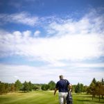 Panoramic view of a lush green golf course at Souris Valley Golf Course. Smooth