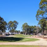 Panoramic view of a lush green golf course at South Creek at Myrtle Beach National. Smooth