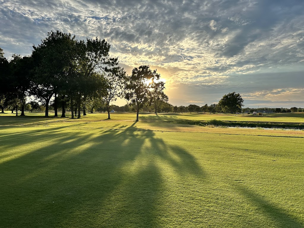Panoramic view of a lush green golf course at South Lakes Golf Course. Smooth