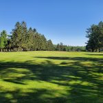 Panoramic view of a lush green golf course at South Mountain Golf Course. Smooth