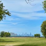 Panoramic view of a lush green golf course at South Shore Golf Course. Smooth