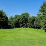 Panoramic view of a lush green golf course at Southampton Country Club. Smooth