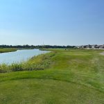 Panoramic view of a lush green golf course at Southern Dunes Golf Course. Smooth