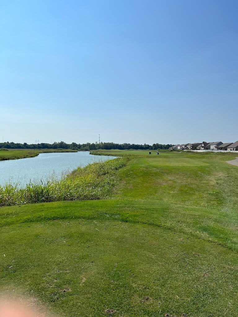 Panoramic view of a lush green golf course at Southern Dunes Golf Course. Smooth