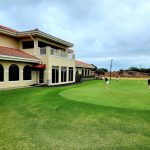 Panoramic view of a lush green golf course at Southern Dunes Golf and Country Club. Smooth
